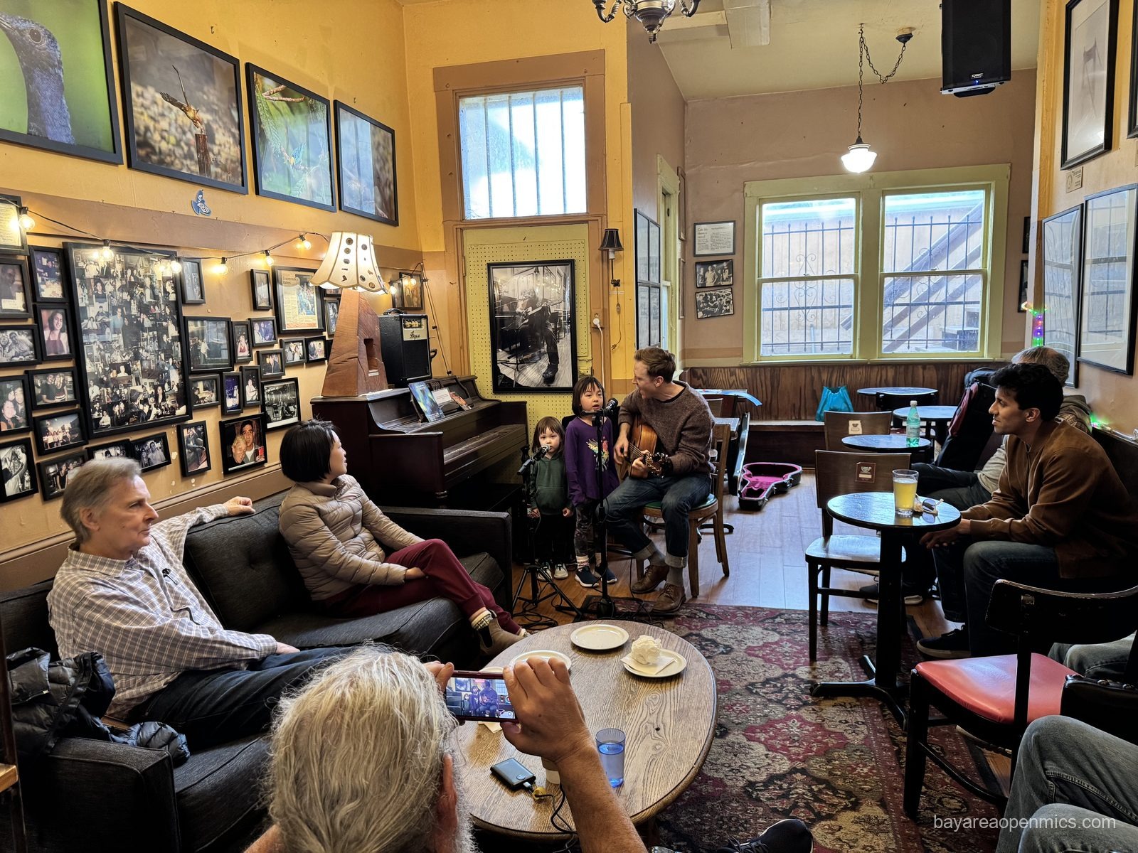 A wide shot of the family performers and audience at Simple Pleasures