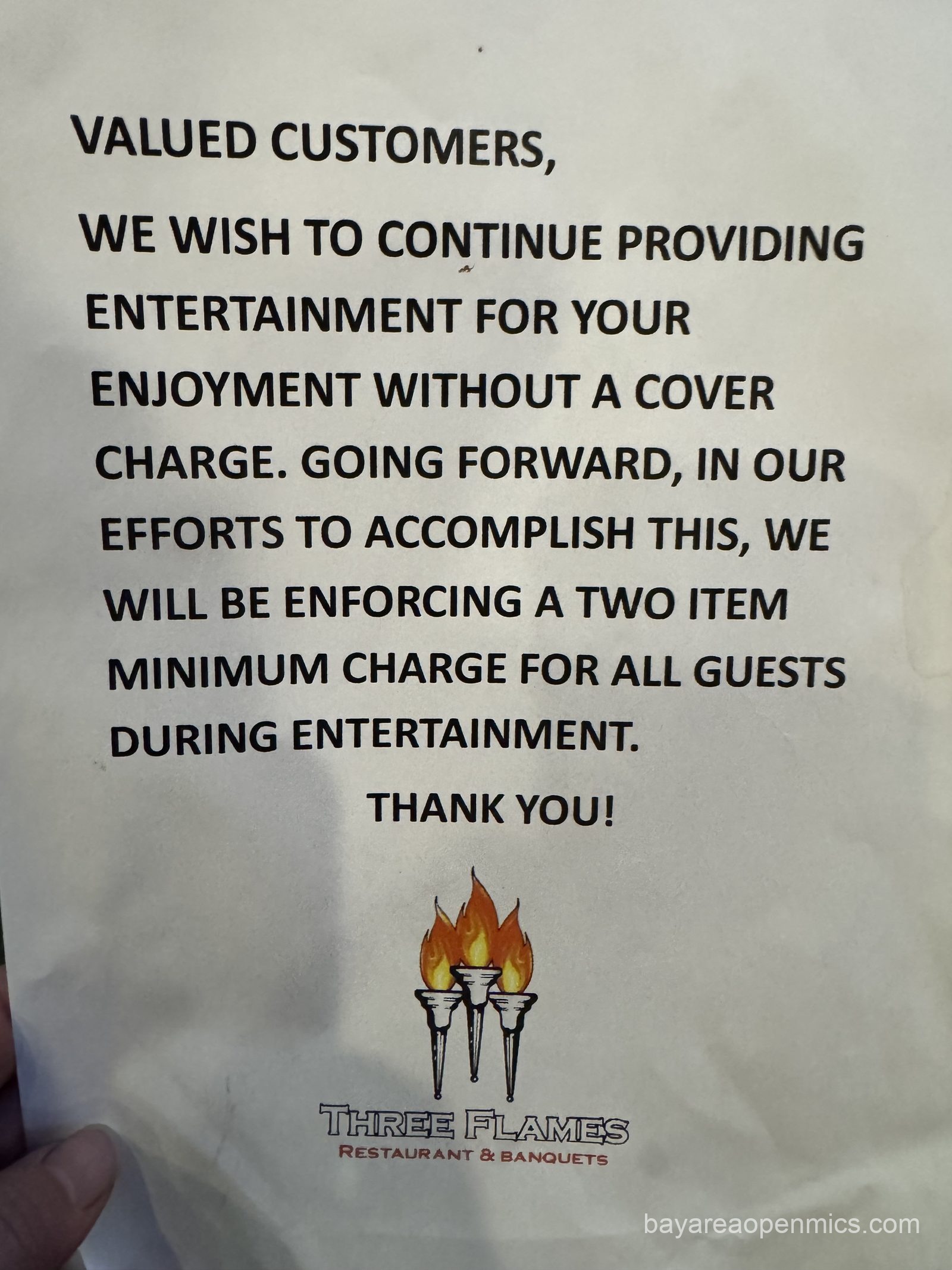 A flyer at Three Flames requesting that open mic attendees order at least two items to support the venue