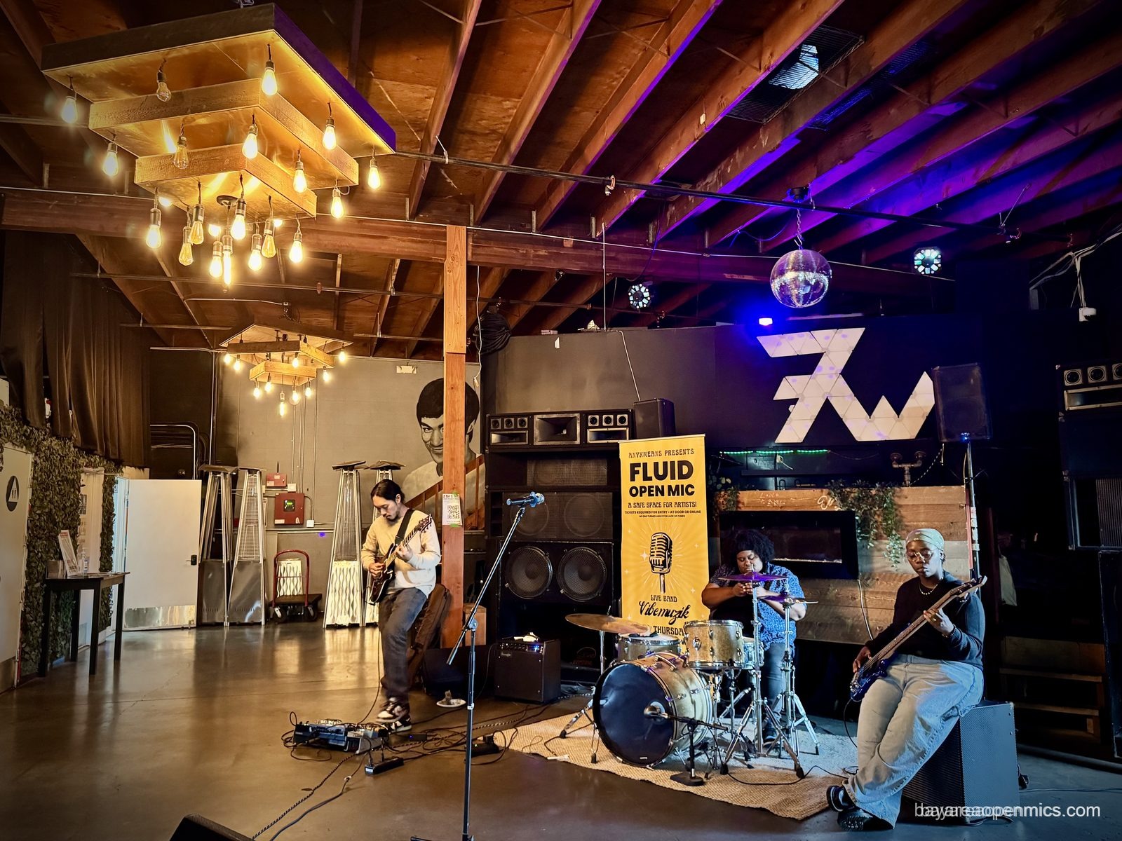 The Vibe Muzik house band backs a performer at the Fluid open mic