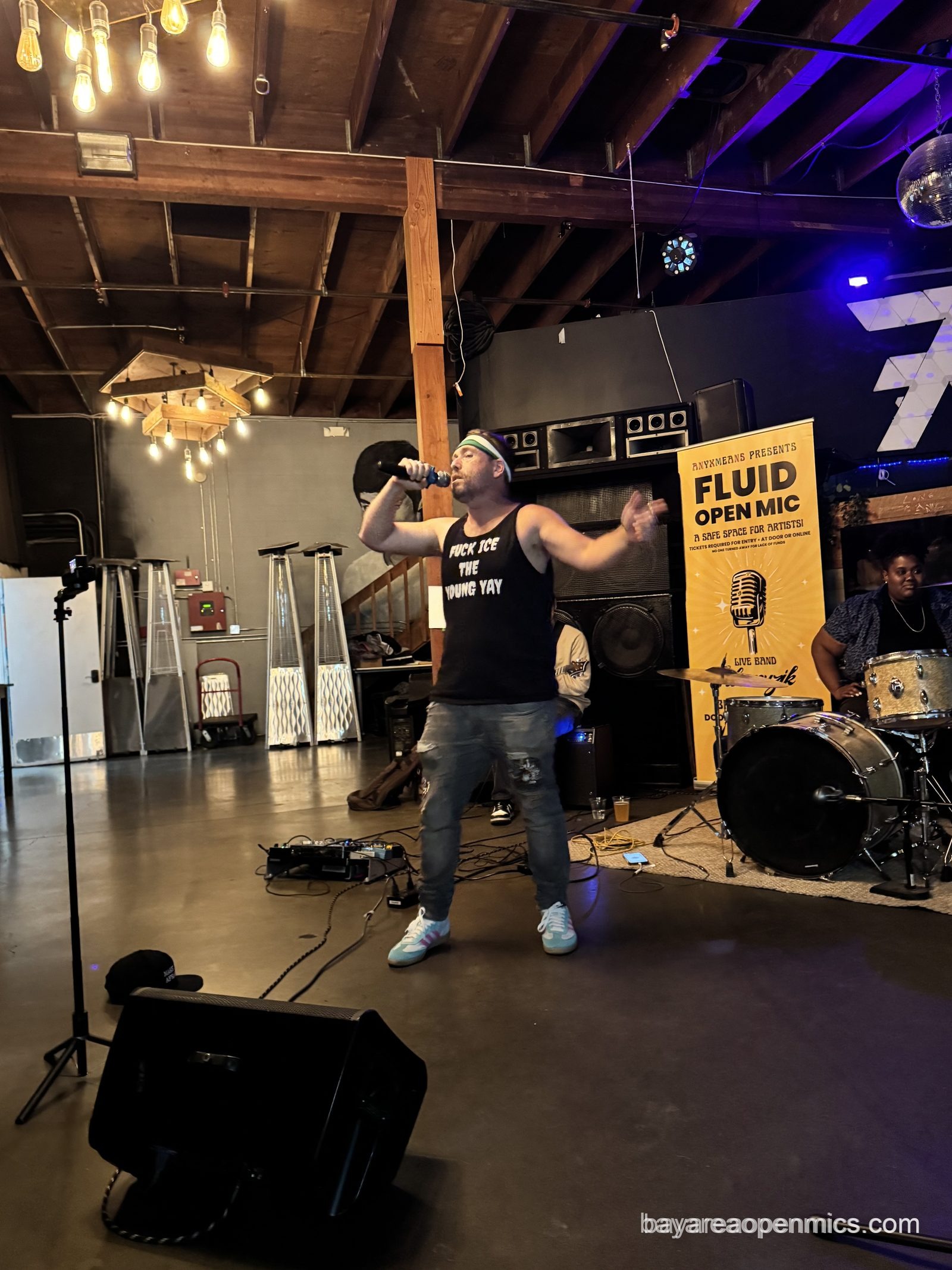 The Young Yay performs with the house band at the Fluid open mic