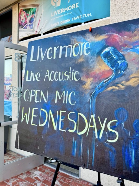Hand-painted open mic sign in the window of Pinot's Palette in Livermore on a Wednesday evening