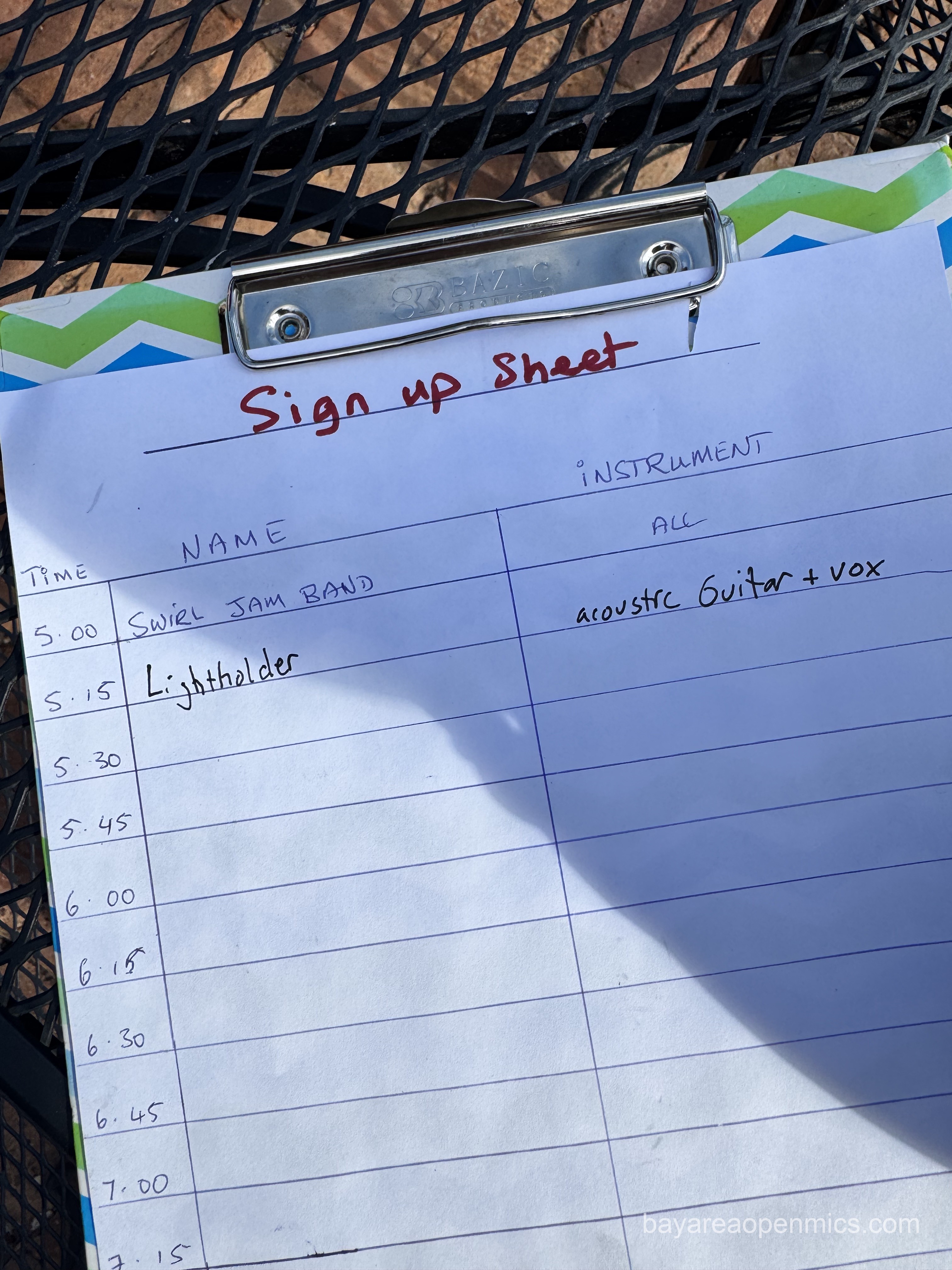 A piece of paper reads 'Sign up list' with just the first two slots written in: 'Swirl Jam Band' followed by 'Lightholder' in the second slot