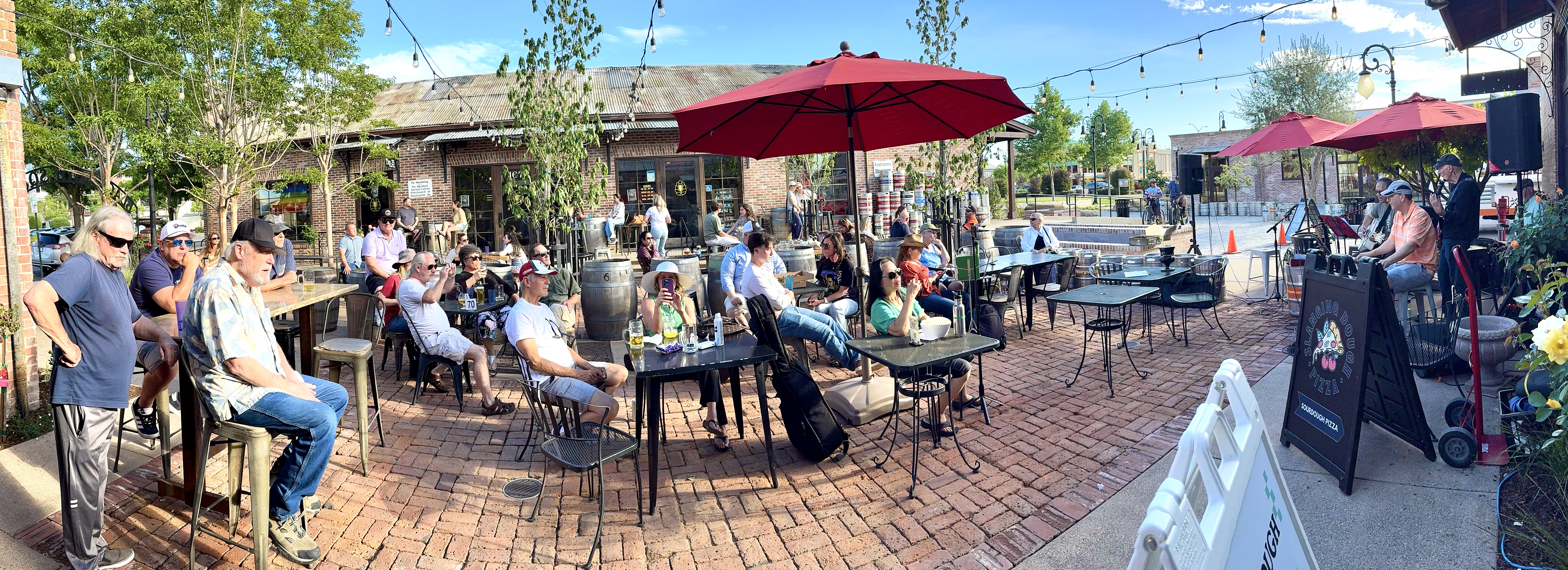 A happy crowd fills the sunny patio to enjoy some music outside Swirl on the Square in Livermore on Easter Sunday