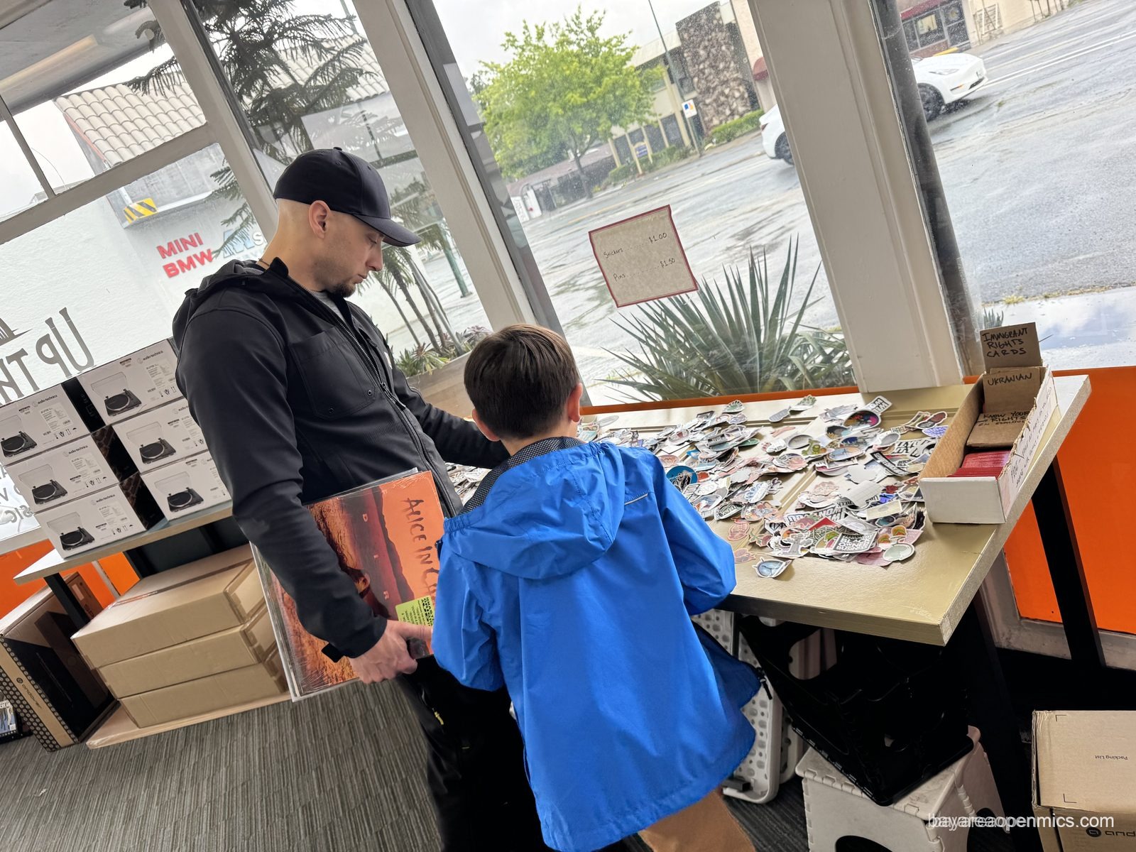 Patrons peruse the buttons and stickers at Up The Creek Records