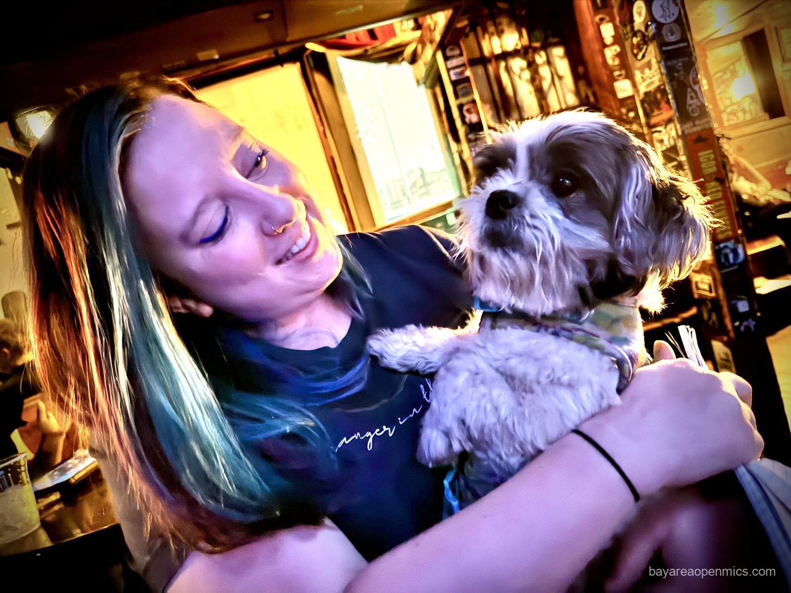 Carly Beltramo with a dog at the Hotel Utah open mic