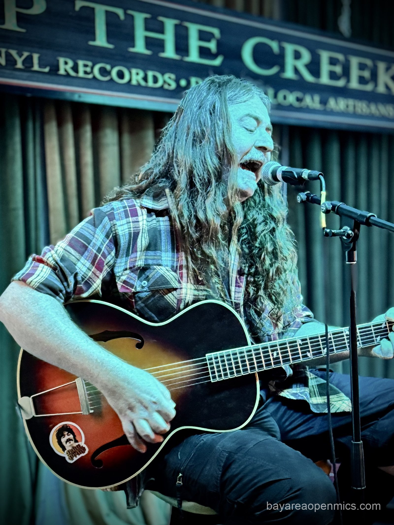 Host Vince Lay performing at The Up The Creek Records open mic